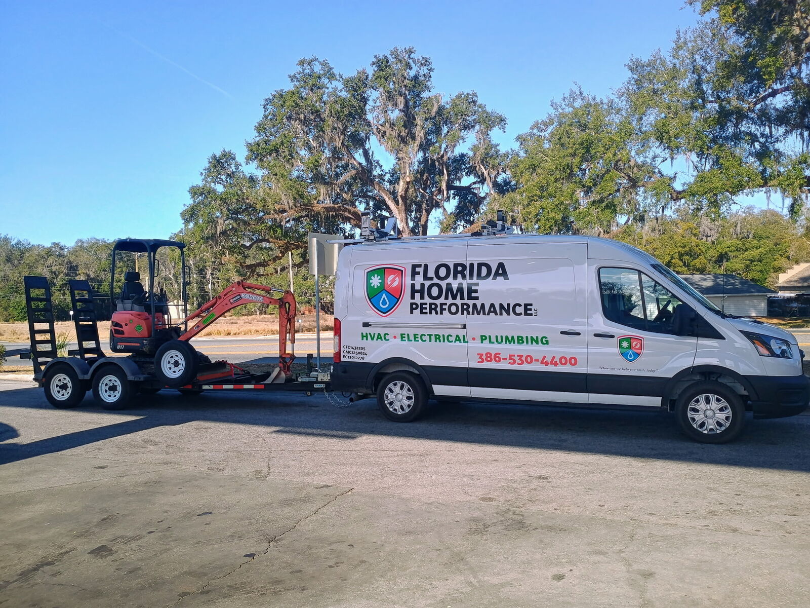 Florida Home Performance van with excavator trailer for plumbing jobs